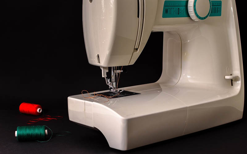 sewing machine with red and green thread